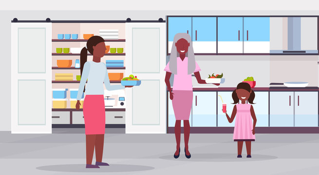 multi generation family preparing food together african american grandmother mother and child daughter having breakfast modern kitchen interior flat horizontal