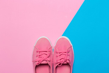 Pink shoes on a pastel background. Top view. Free space for text.