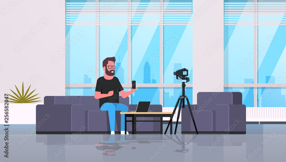 Poster guy technology blogger recording video on camera man showing new smartphone functional testing blog 