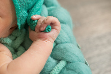 Fingers of a newborn baby, toes  hands and nails of a child, the first days of life after birth, scaly skin.