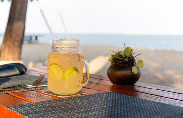 Lemon and honey drink with slice of lime on table refreshing summer drink.