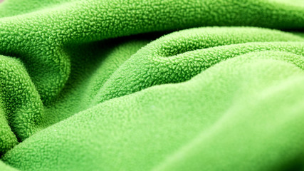 texture of green fleece fabric. soft to the touch fabric, pleasant to the skin