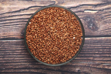 A glass bowl with raw buckwheat