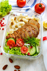 Lunch box: rotini with baked chicken breast and salad. Delicious healthy lunch. The concept of healthy eating.