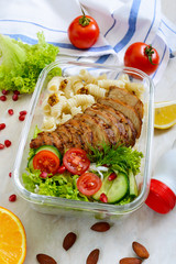 Lunch box: rotini with baked chicken breast and salad. Delicious healthy lunch. The concept of healthy eating.