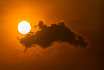 Bright yellow sunrise sunset with big sun and clouds