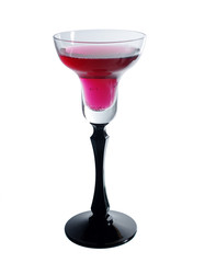 A glass of cocktail on a light background.