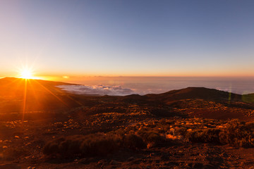 Incredible sunset landscape in the mountains. Clouds lie on the mountainside