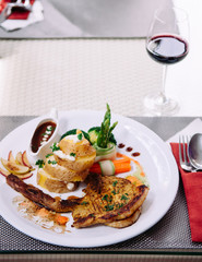 Beautiful pork chop, baked potato, boiled vegetable and brown gravy.