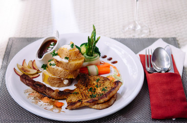 Beautiful pork chop, baked potato, boiled vegetable and brown gravy.