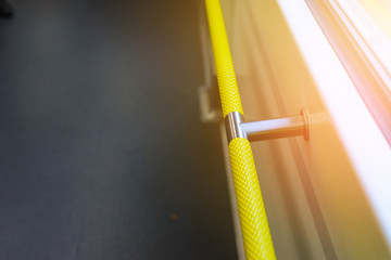 Yellow handle railings for standing passengers inside train or bus