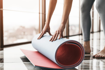 Young slim attractive woman with long hair practicing yoga indoors.