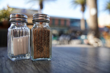 Salt and pepper shaker on a wood table