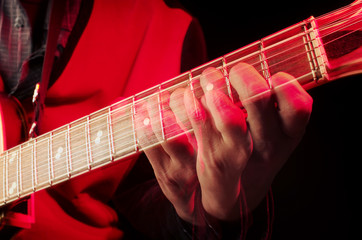 The dynamics of playing the guitar. Guitarist fingers spread all over the fretboard. Repeated...
