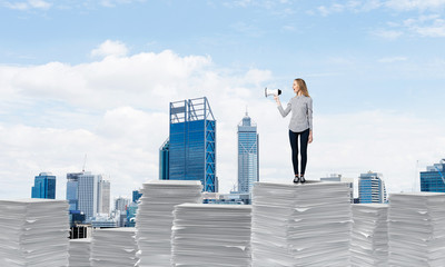 Woman keeping megaphone in hand.