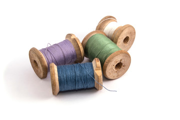 green blue purple white sewing thread on white background isolated