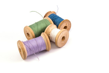 green blue purple white sewing thread on white background isolated