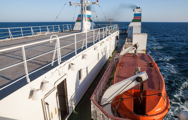Orange lifeboat on passenger ship