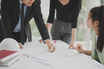 Teamwork concept.Team meeting. Young people standing discussing. business news and paperwork on the table in office.