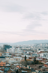 Fototapeta premium Sunset and evening city Tbilisi, Georgia. Panoramic views and lights of historic neighborhoods.
