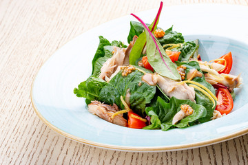 Mix salad with chicken and tomatoes. On light background