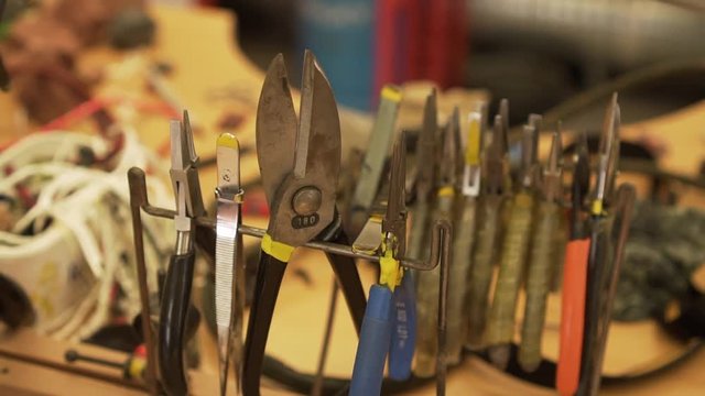 Detail of pliers on the stand in workroom / garage