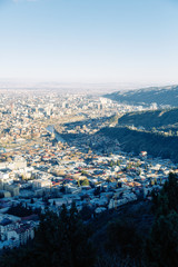 Sunset and evening city Tbilisi, Georgia. Panoramic views and lights of historic neighborhoods.