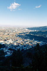 Sunset and evening city Tbilisi, Georgia. Panoramic views and lights of historic neighborhoods.