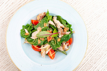 Mix salad with chicken and tomatoes. On light background