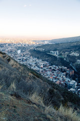 Sunset and evening city Tbilisi, Georgia. Panoramic views and lights of historic neighborhoods.
