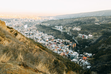 Sunset and evening city Tbilisi, Georgia. Panoramic views and lights of historic neighborhoods.