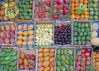 Fruit trays for sale of mangoes, pomegranates, bananas, plums, guava, oranges