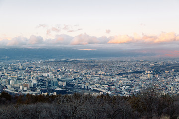 Sunset and evening city Tbilisi, Georgia. Panoramic views and lights of historic neighborhoods.