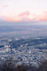 Sunset and evening city Tbilisi, Georgia. Panoramic views and lights of historic neighborhoods.