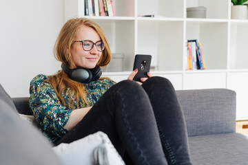 Pretty young woman listening to music on a mobile