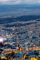 Fototapeta na wymiar Sunset and evening city Tbilisi, Georgia. Panoramic views and lights of historic neighborhoods.