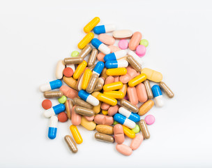 set of multi-colored tablets and capsules on a white background