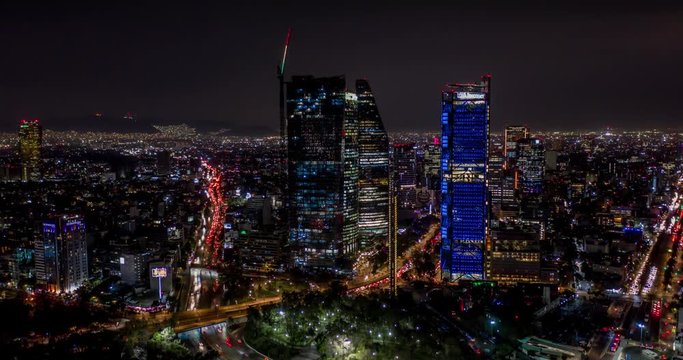 Aerial hyperlapse of the skyscrapers of Paseo de la Reforma at night in Mexico City.