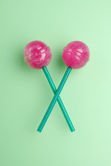 Colorful lollipops isolated. Candy concept on mint green background with copy space