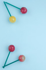 Sweet colorful lollipops isolated on blue background. Lollipop concept. Copy space for text.