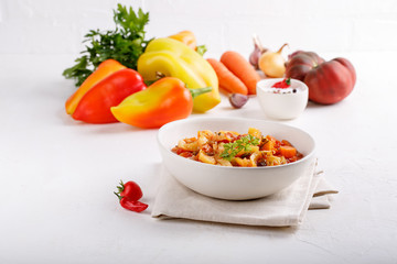 Stewed vegetables. Vegetable ragout of sweet pepper, carrot, onion, tomatoes. Vegetarian food.