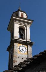 Alter Kirchturm im Tessin vor blauem Himmel