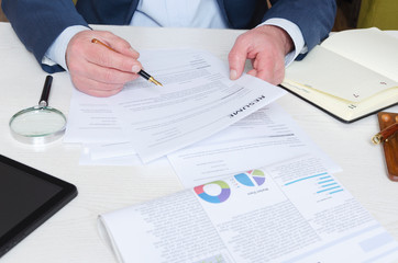 Professional headhunter reviewing resume at the desk and making decision before hiring employee