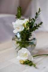 white freesia flowers in a round vase
