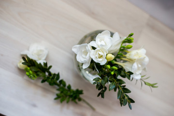 white freesia flowers in a round vase