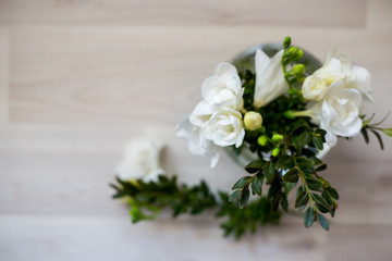 white freesia flowers in a round vase