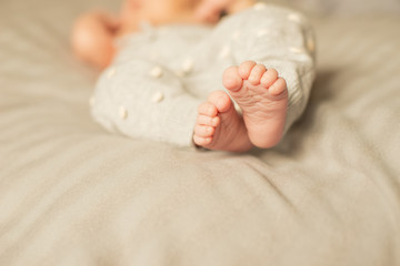 Feet of tiny newborn baby close up. The concept of a happy family. Beautiful conceptual image of...