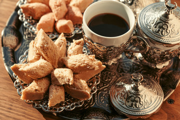 Turkish sweets with coffee on a wooden table