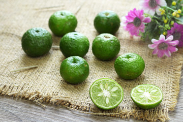 fresh lime fruit on burlap background