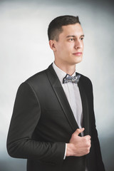 Beautiful fashion man in a suit and a butterfly